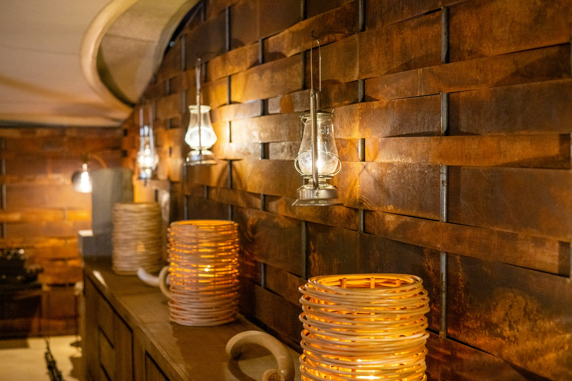 a row of lamps sitting on top of a wooden shelf